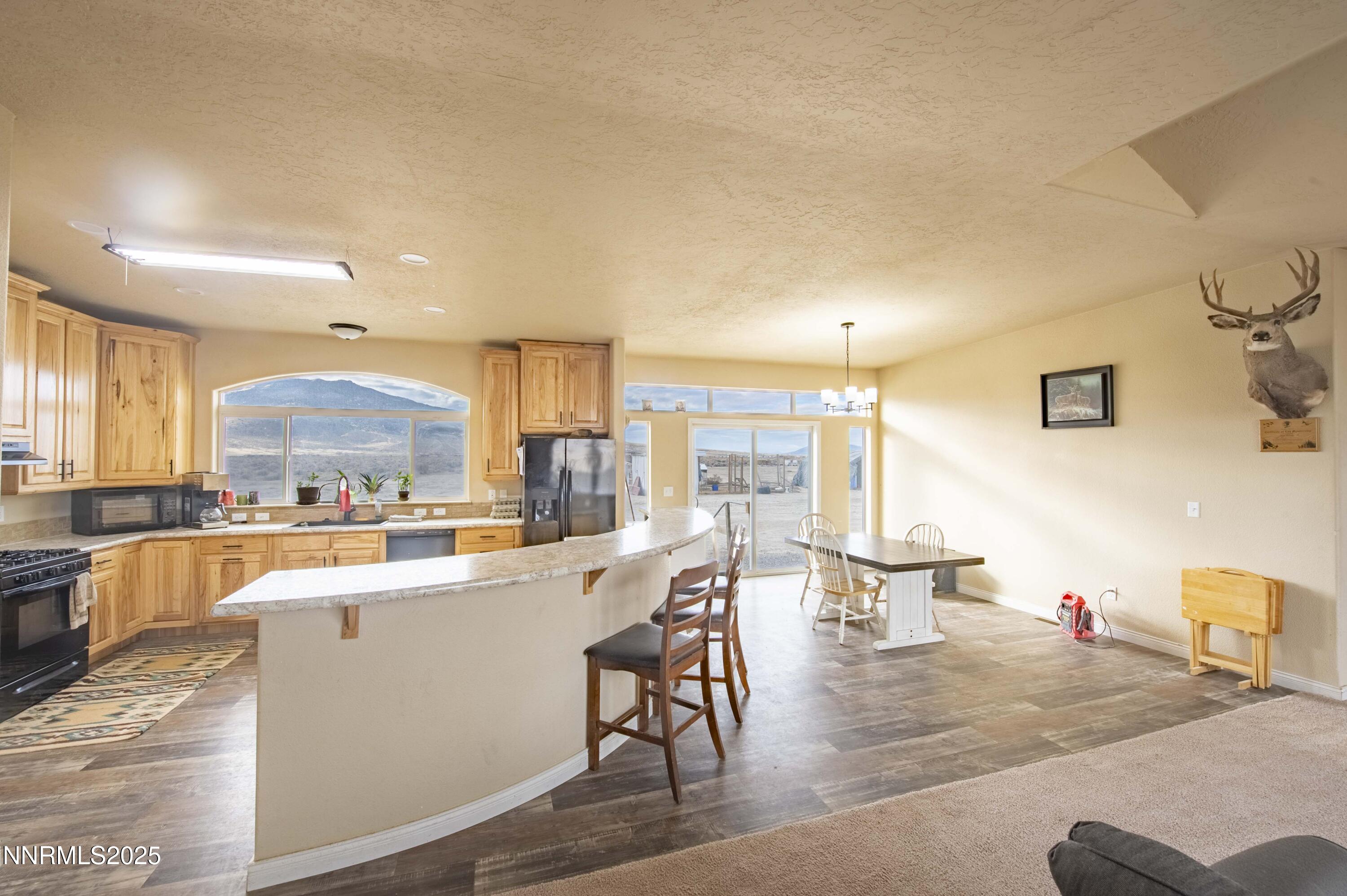 3139 Muddy Road Winnemucca, NV 89445 - Photo 35 of 46 a kitchen with a table chairs stove and cabinets