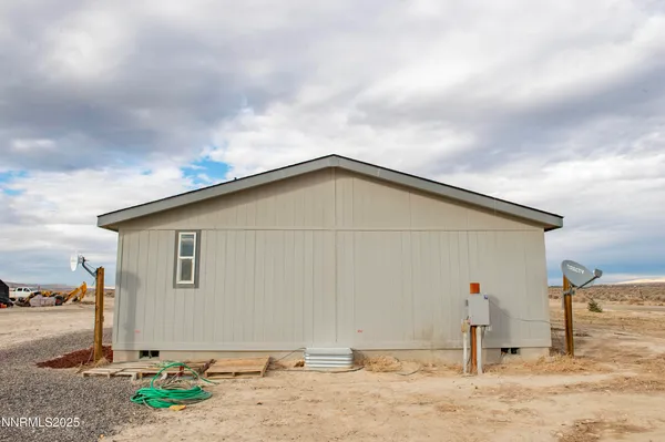 a view of a house with cars parked in front of it