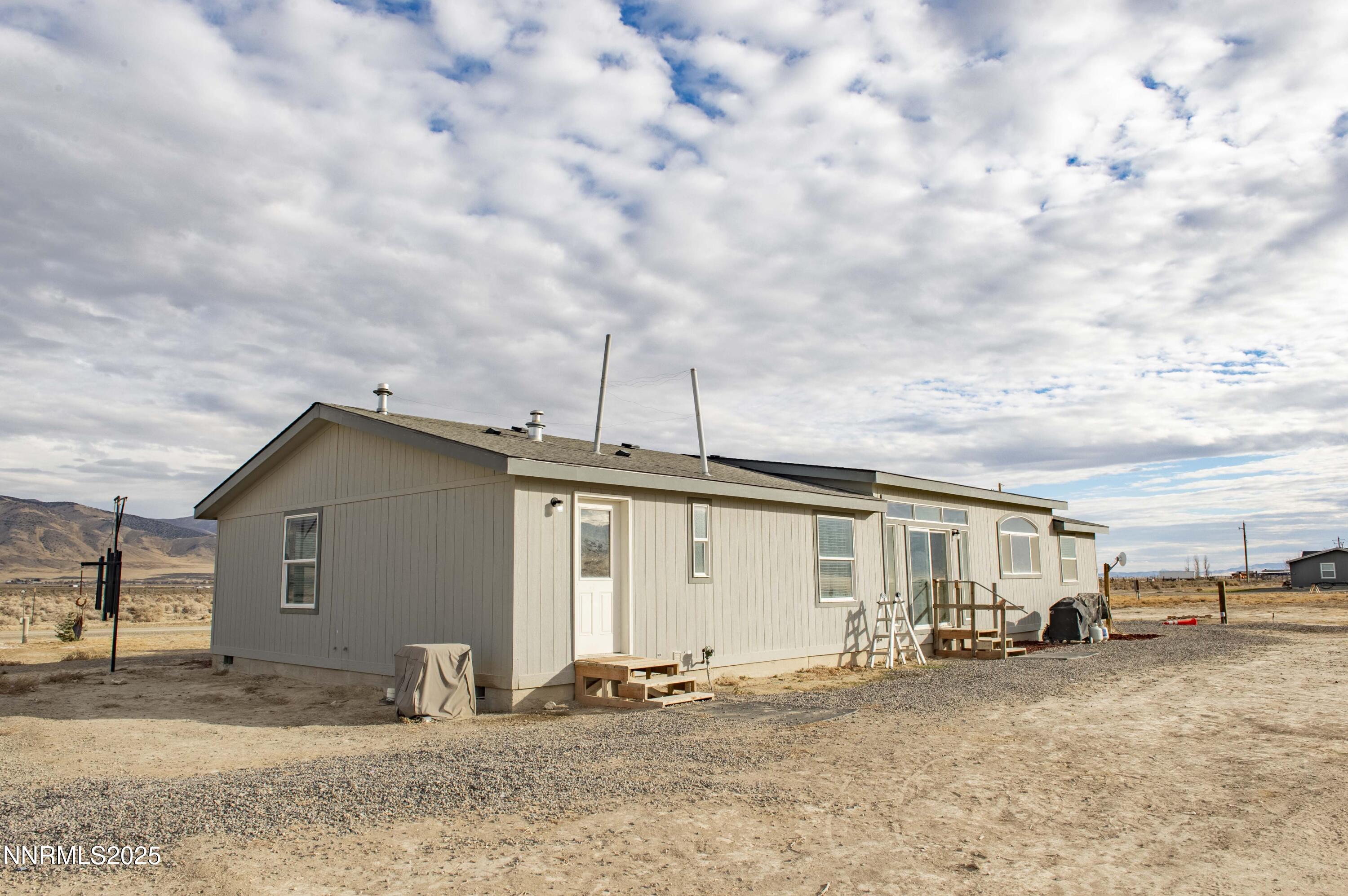 3139 Muddy Road Winnemucca, NV 89445 - Photo 41 of 46 a front view of a house with a yard and garage