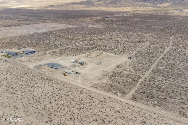 a view of a dining room and livingroom with furniture wooden floor a chandelier
