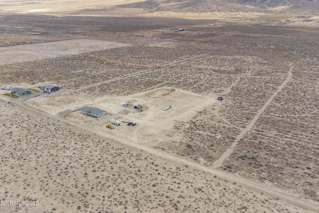 a view of a dining room and livingroom with furniture wooden floor a chandelier