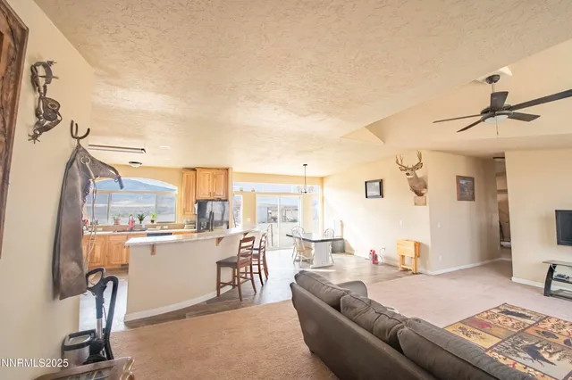 a living room with furniture and a view of kitchen