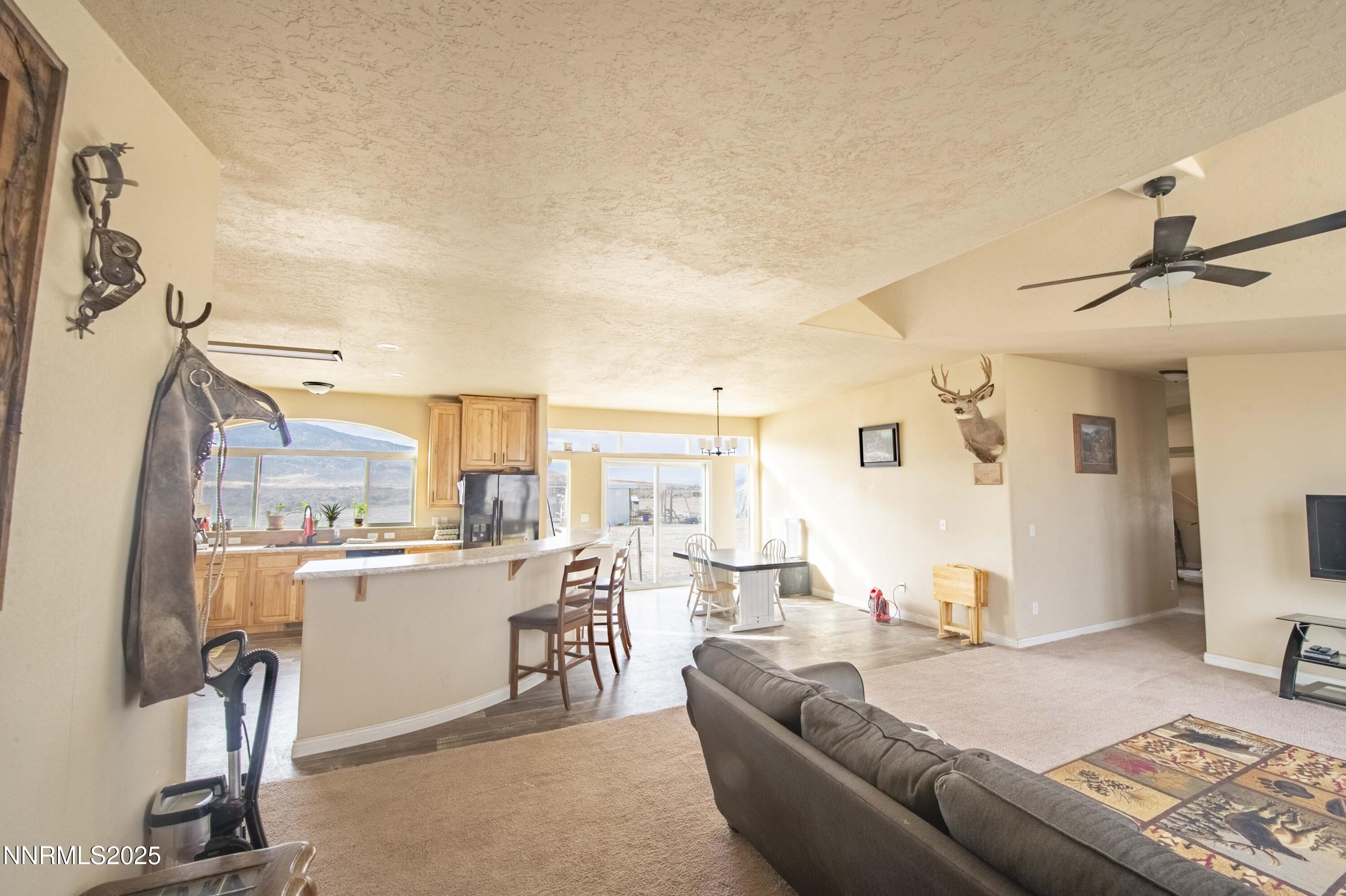 3139 Muddy Road Winnemucca, NV 89445 - Photo 8 of 46 a living room with furniture a refrigerator and a table
