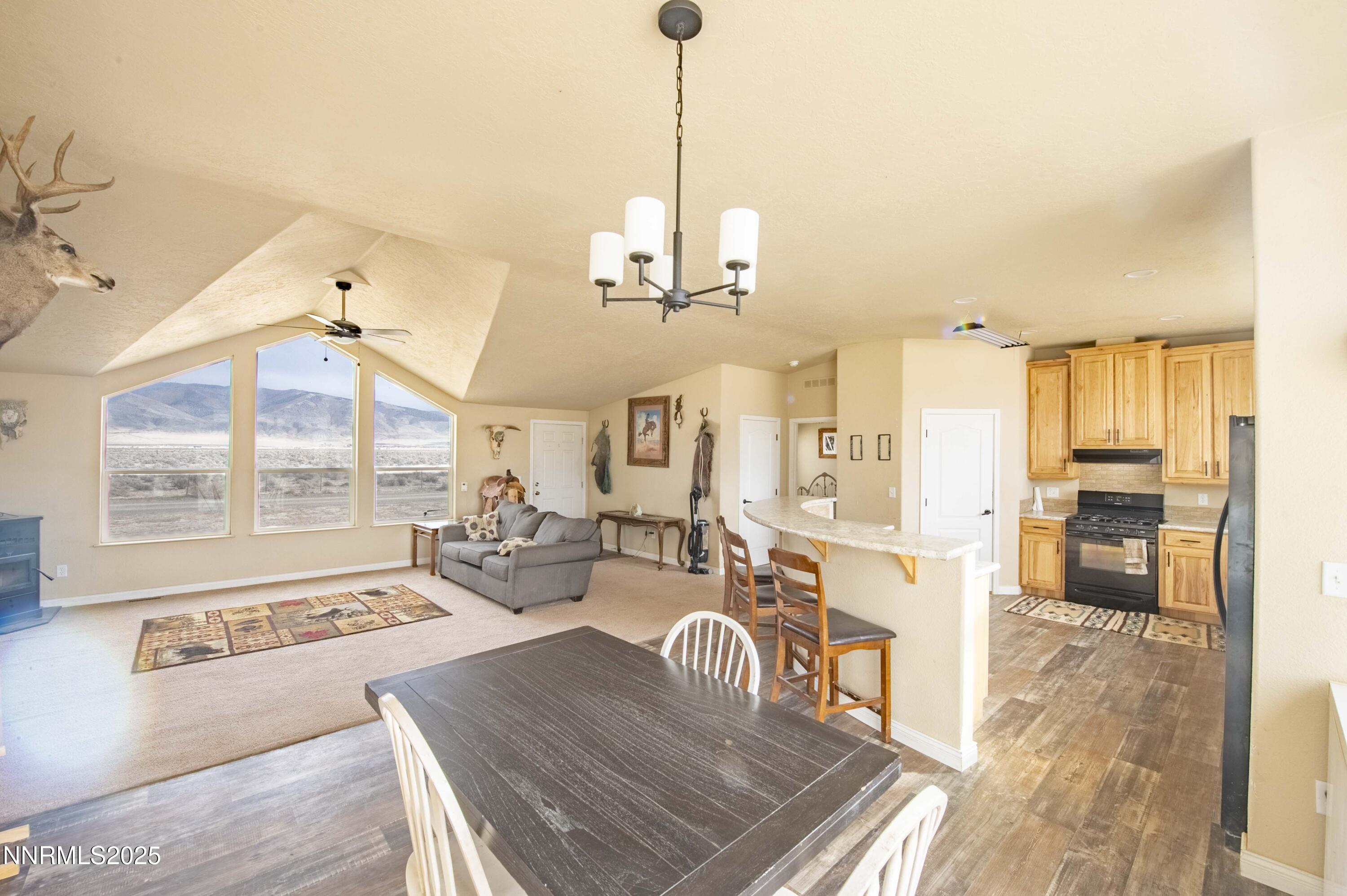 3139 Muddy Road Winnemucca, NV 89445 - Photo 10 of 46 a view of a dining room and livingroom with furniture wooden floor a chandelier