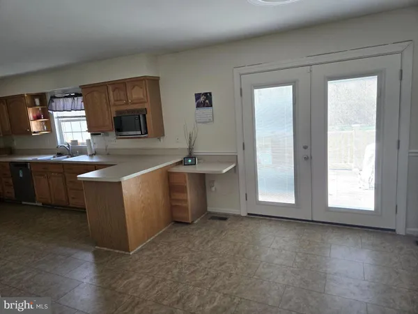 a view of a kitchen with a sink a fireplace and a window