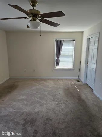a view of room with a ceiling fan