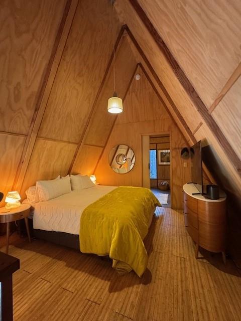 10 Beasore Road Bass Lake, CA 93604 - Photo 6 of 15 a bedroom with a bed and wooden floor