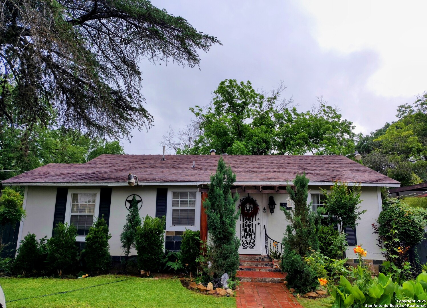 a view of a house with garden and plants