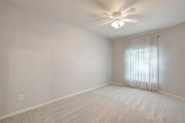 a view of an empty room with a fan
