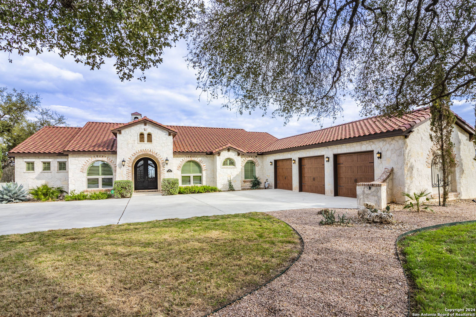 a front view of a house with yard and garage