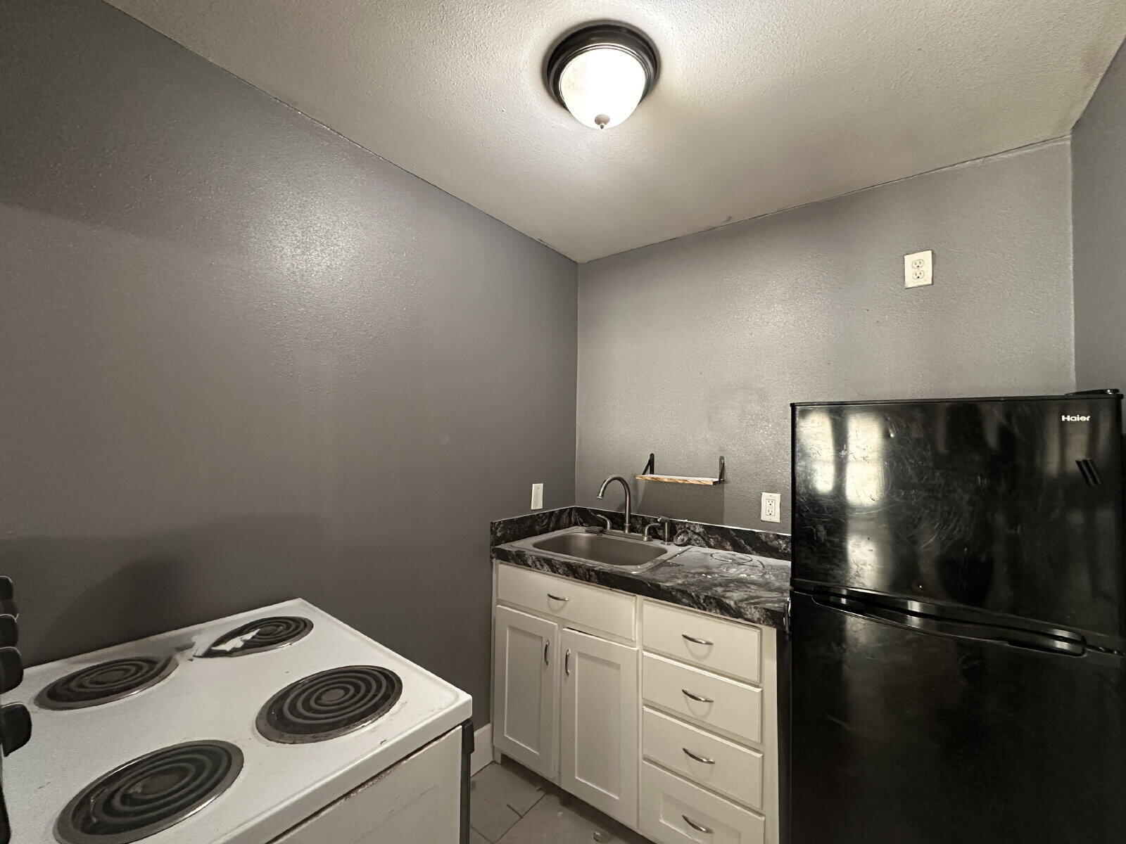 2622 32nd Street, Unit REAR Lubbock, TX 79410 - Photo 5 of 6 a kitchen that has a stove and a refrigerator