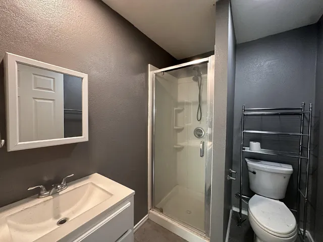a bathroom with a sink toilet and shower