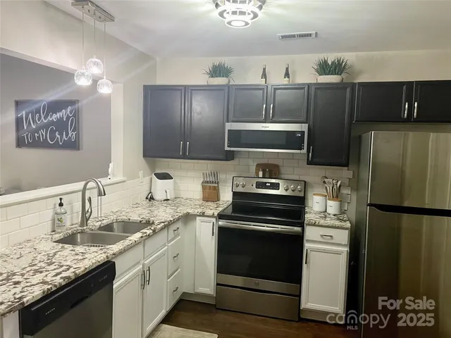 a kitchen with a sink stove and refrigerator