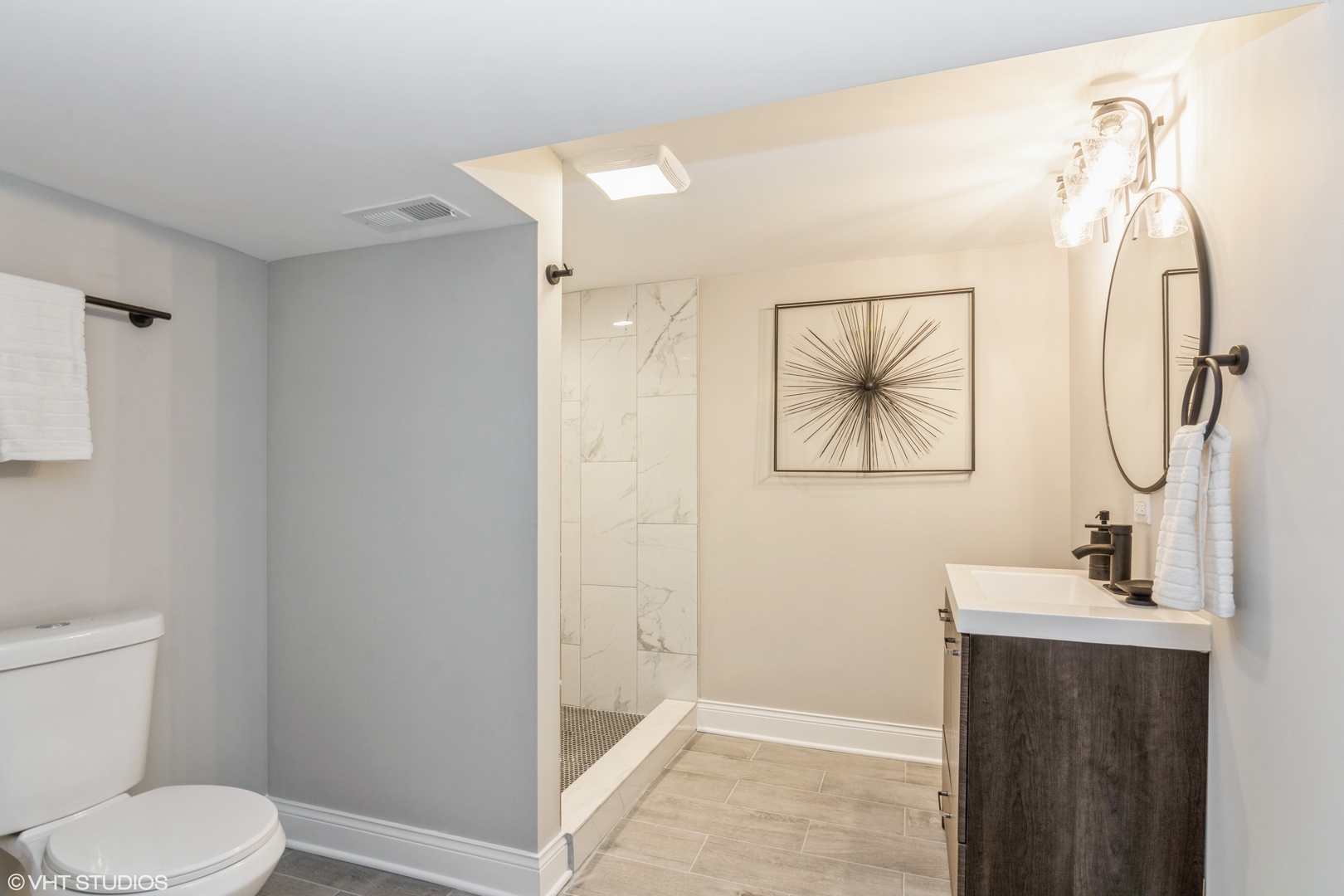 9044 South Carpenter Street Chicago, IL 60620 - Photo 14 of 14 a bathroom with a toilet sink vanity and mirror