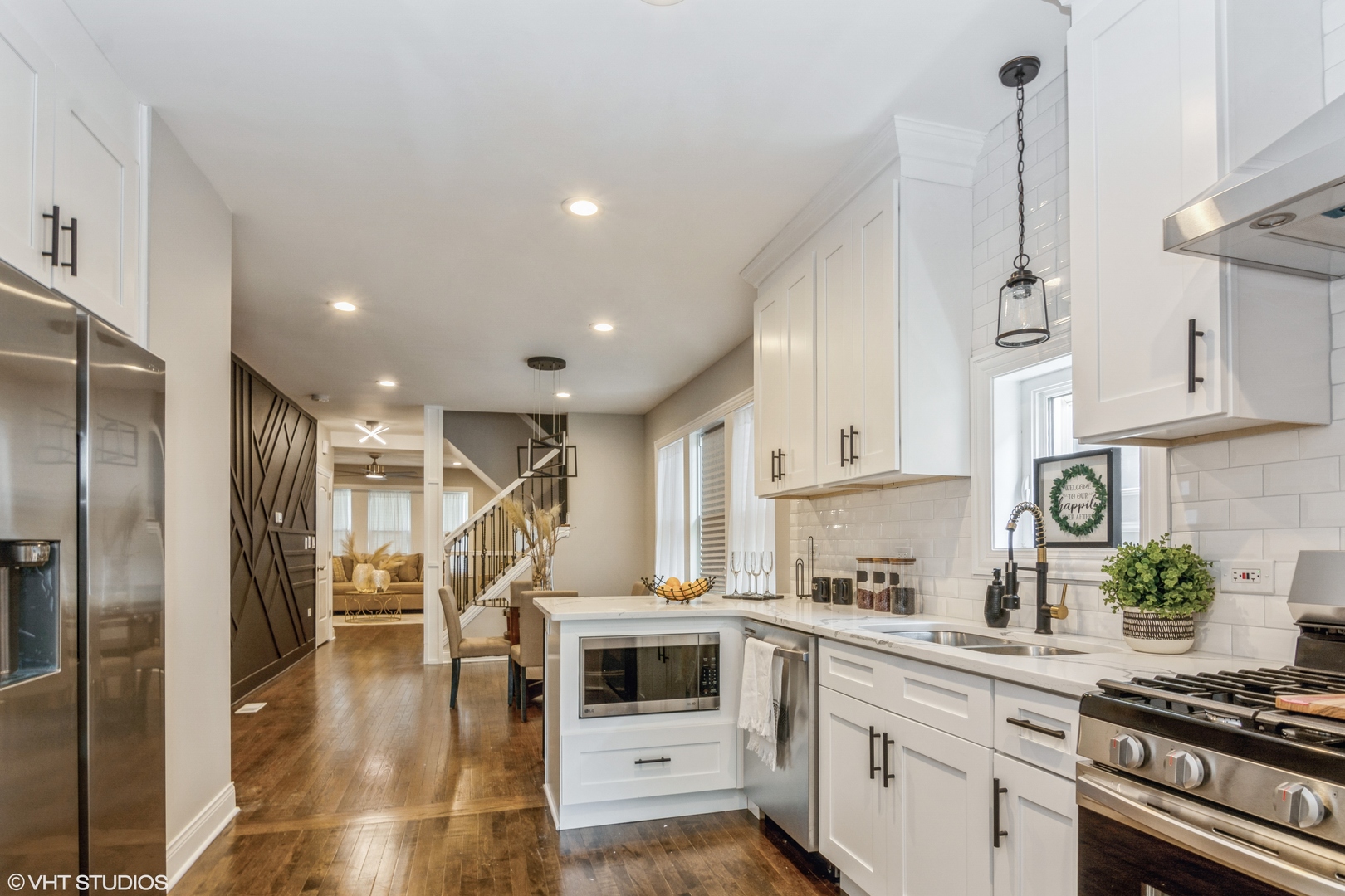 9044 South Carpenter Street Chicago, IL 60620 - Photo 6 of 14 a kitchen with stainless steel appliances kitchen island granite countertop a refrigerator a stove and white cabinets with wooden floors