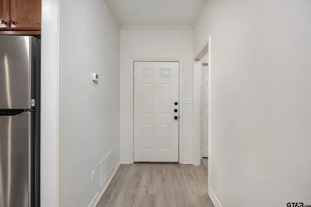 a view of a hallway with wooden floor