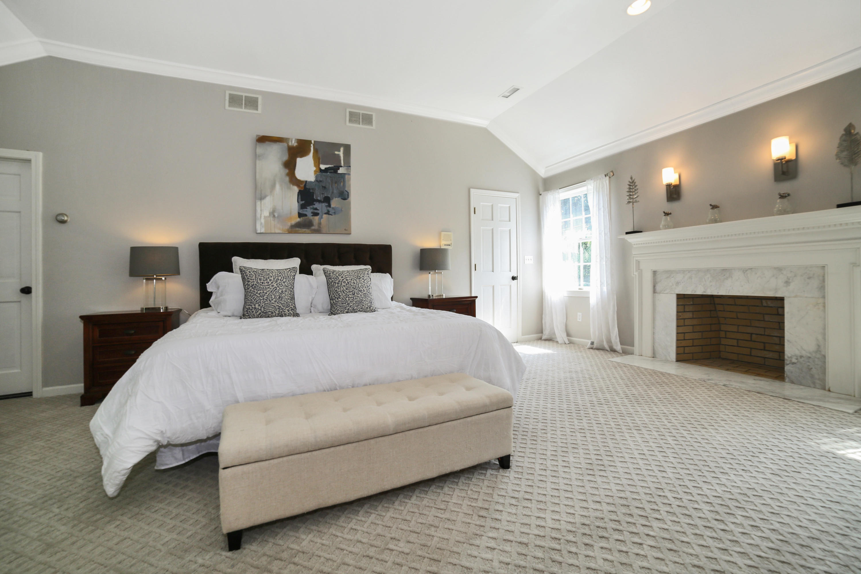 48 Hoyt Farm Road New Canaan, CT 06840 - Photo 15 of 26 a spacious bedroom with a bed and a fireplace