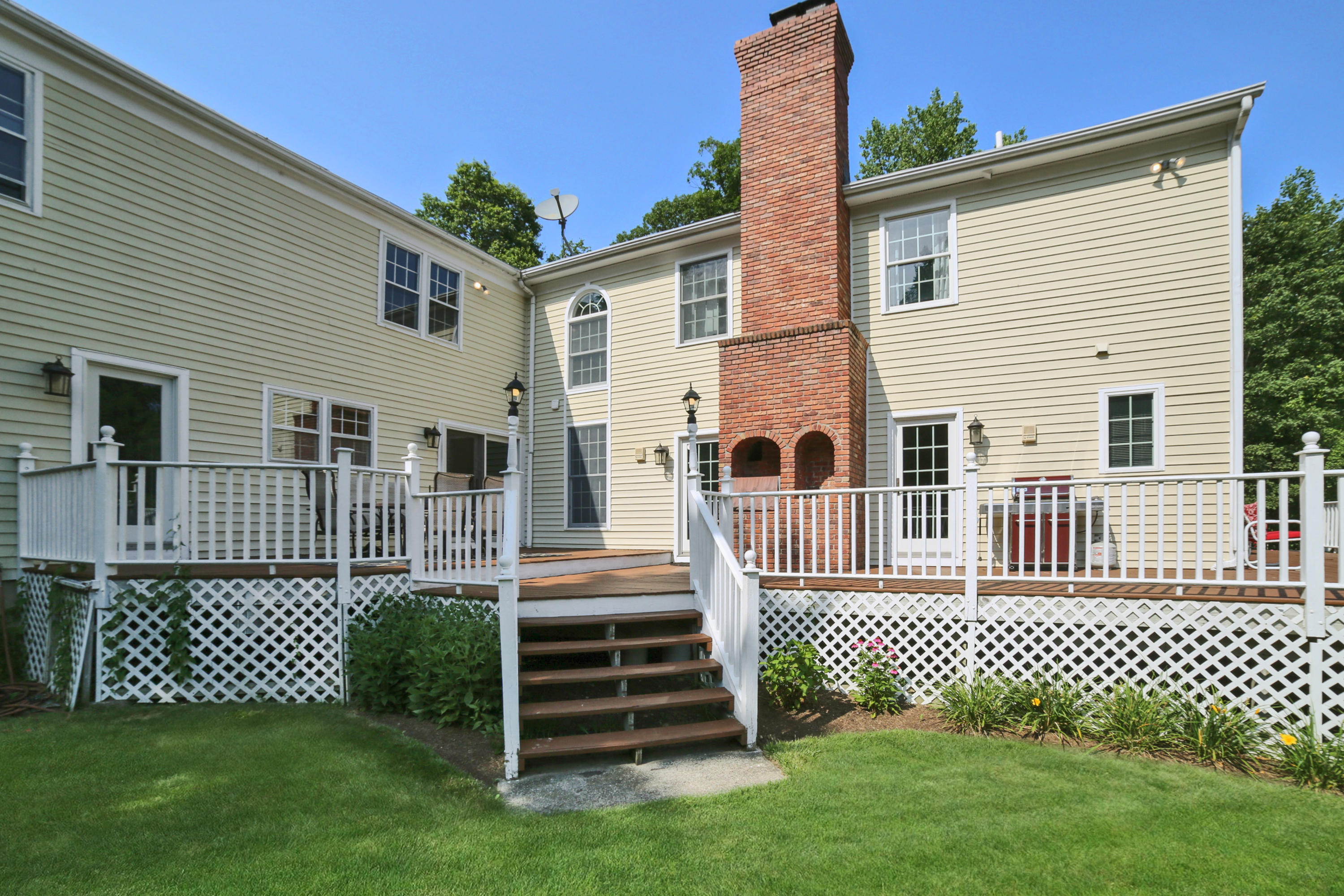 48 Hoyt Farm Road New Canaan, CT 06840 - Photo 24 of 26 a front view of a house with a garden