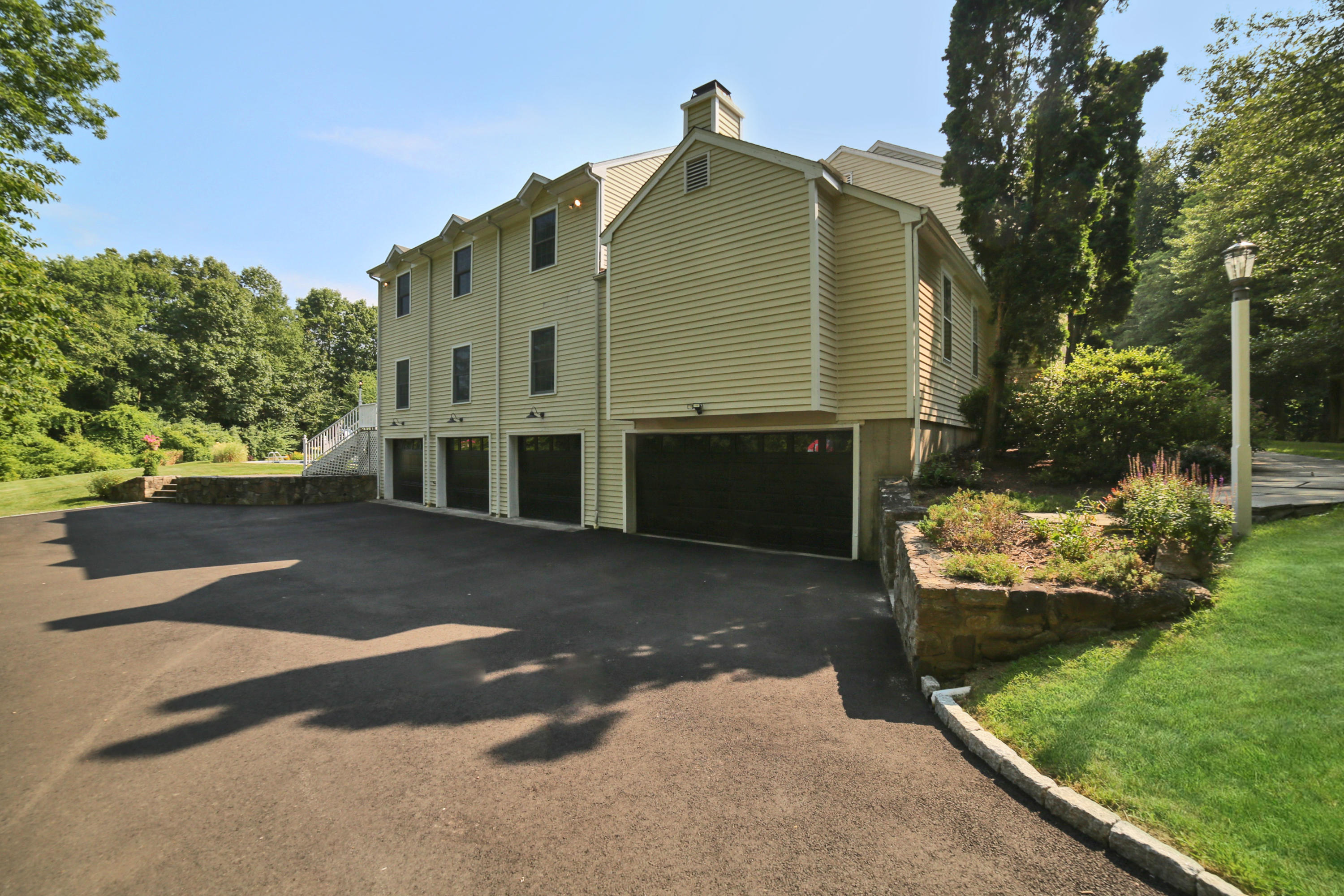 48 Hoyt Farm Road New Canaan, CT 06840 - Photo 25 of 26 a front view of a house with a yard
