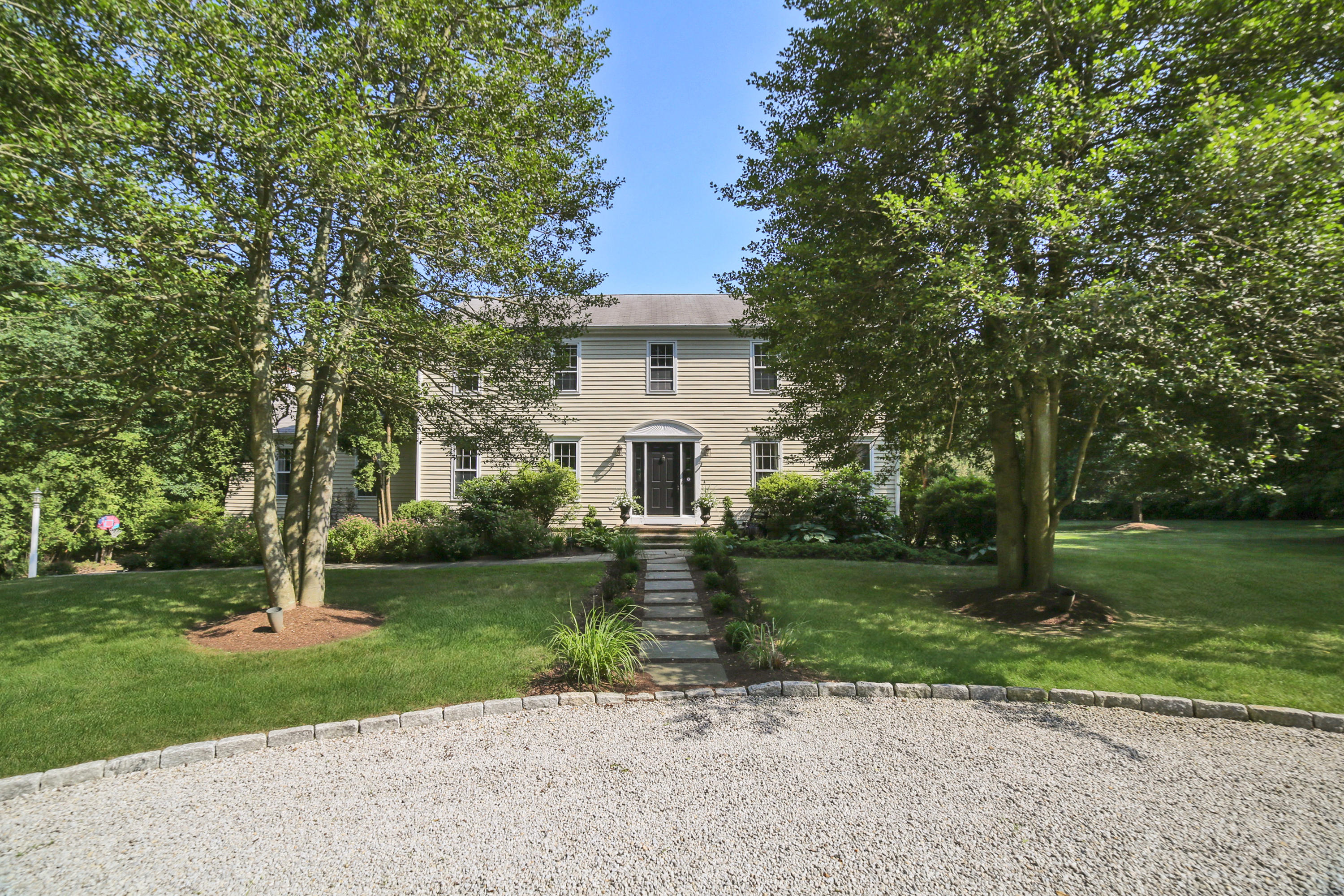 48 Hoyt Farm Road New Canaan, CT 06840 - Photo 5 of 26 a front view of a house with a yard