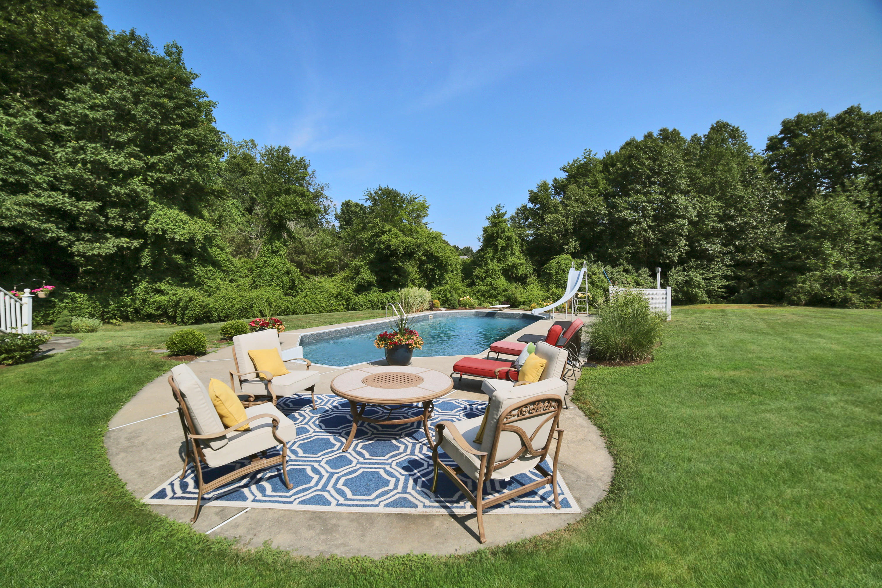 48 Hoyt Farm Road New Canaan, CT 06840 - Photo 6 of 26 a view of a chairs and backyard in the green field