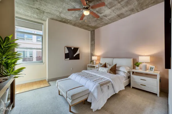 a bedroom with bed and a potted plant