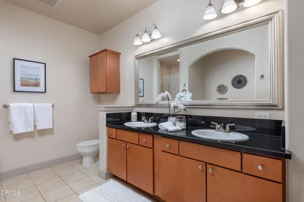 a bathroom with a double vanity sink and a mirror