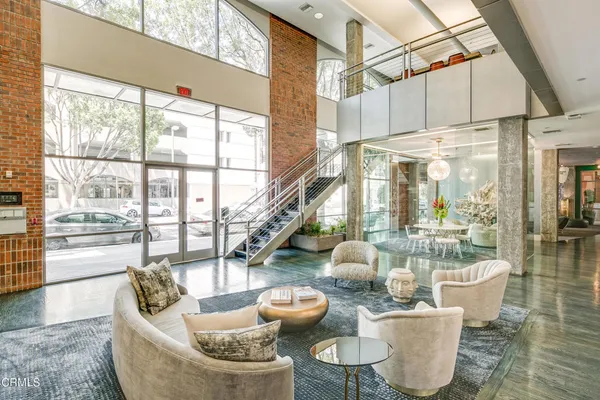 a dining room with furniture a chandelier and wooden floor