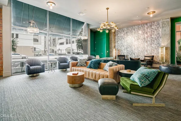 a living room with furniture and a chandelier