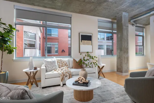 a living room with furniture and a potted plant