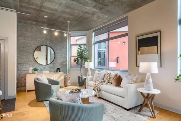 a living room with furniture and a large mirror