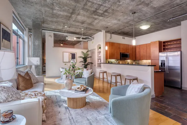 a living room with furniture and a kitchen view