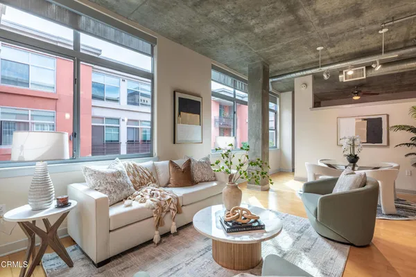 a living room with furniture and flowers