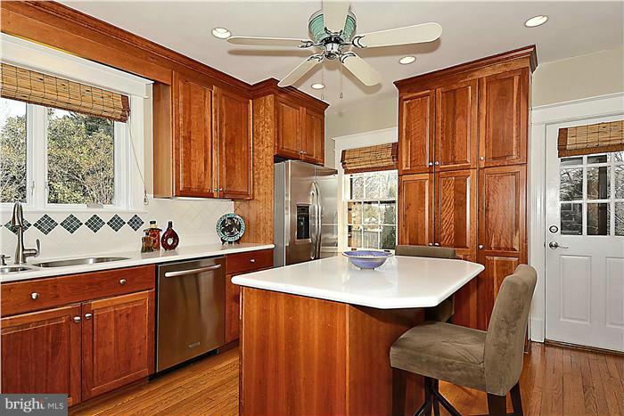 1914 Stratton Road Silver Spring, MD 20910 - Photo 4 of 13 a kitchen with stainless steel appliances granite countertop a sink window and cabinets
