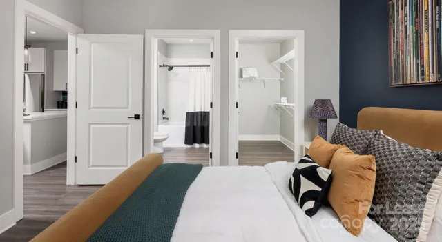 a kitchen with a refrigerator sink and white cabinets