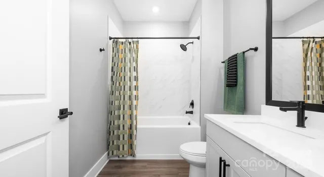 a kitchen with stainless steel appliances granite countertop a sink and a refrigerator