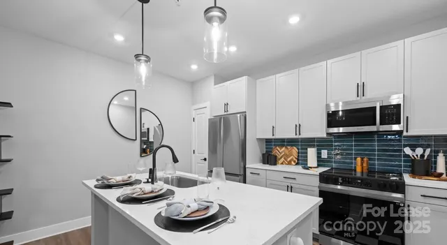 a living room with furniture and kitchen view