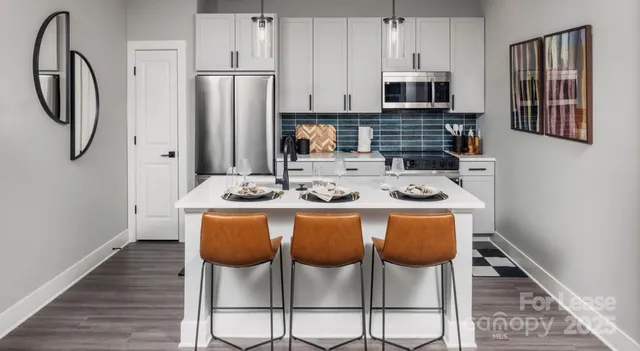 a view of a hallway with wooden floor and cabinet