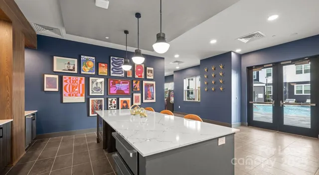 a kitchen with stainless steel appliances granite countertop a sink and a refrigerator
