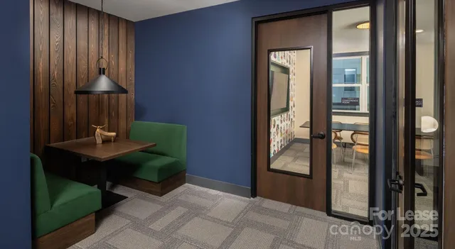 a living room with furniture a window and gym equipment