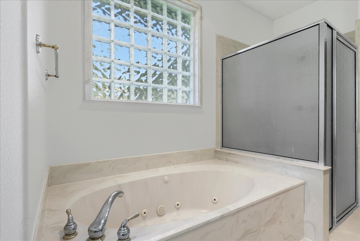 1607 Delta Lane Baytown, TX 77523 - Photo 26 of 48 The primary bathroom has a large tub and shower.