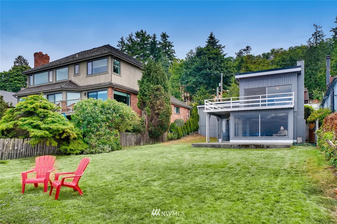 5633 Beach Drive Southwest Seattle, WA 98136 - Photo 2 of 25 a view of a backyard with table and chairs and potted plants with wooden fence