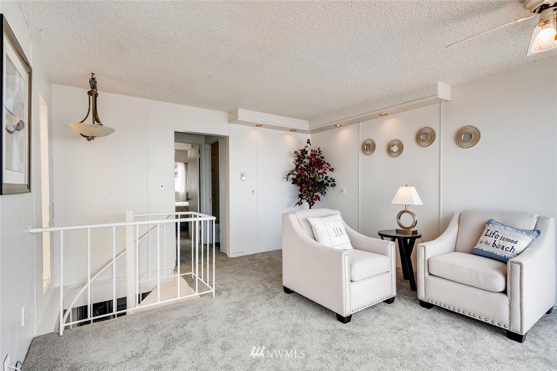 5633 Beach Drive Southwest Seattle, WA 98136 - Photo 6 of 25 a living room with furniture and a chandelier