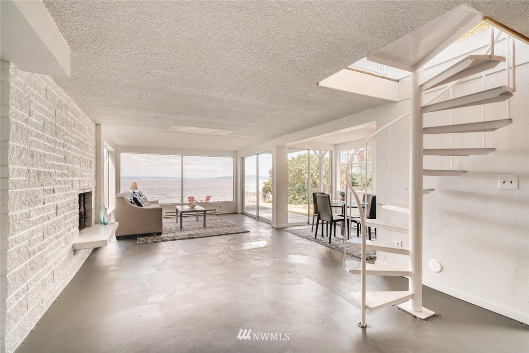 5633 Beach Drive Southwest Seattle, WA 98136 - Photo 10 of 25 a living room with furniture and large windows