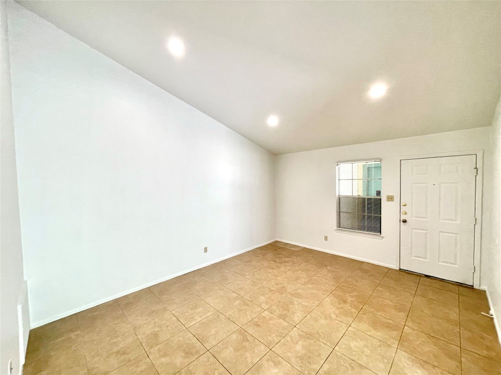 1802 Prairie Knoll Court, Unit B Austin, TX 78758 - Photo 2 of 10 an empty room with a empty space and windows