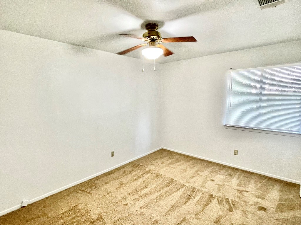 1802 Prairie Knoll Court, Unit B Austin, TX 78758 - Photo 5 of 10 a view of a room with a ceiling fan and a window