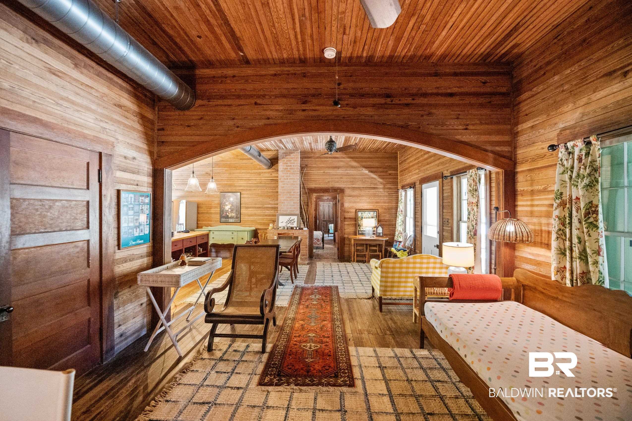 30671 Magnolia Street Elberta, AL 36530 - Photo 37 of 68 Interior space with wooden ceiling, wooden walls, wood finished floors, arched walkways, and a towering ceiling