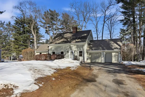 a view of a house with a yard covered with snow