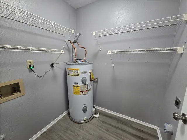 a view of storage and utility room with wooden floor