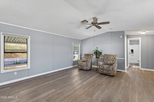 a living room with furniture and wooden floor